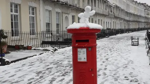 Alice Veg Grower A post box in Royal York Crescent in Clifton, Bristol with a snow man topping
