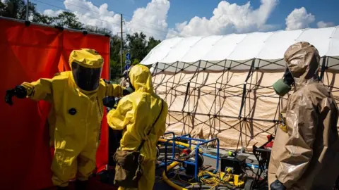 Getty Images Ukrainian Emergency Ministry rescuers attend an exercise in the city of Zaporizhzhia on August 17, 2022, in case of a possible nuclear incident at the Zaporizhzhia nuclear power plant located near the city