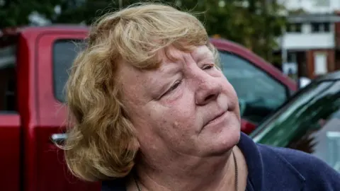 BBC Portrait of Margaret Grassie leaning against car