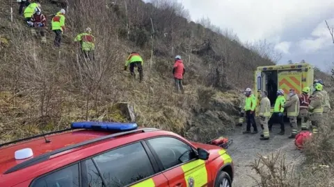 Brecon Mountain Rescue Team Rescue operation to save paraglider on hillside above Hundred House, Powys