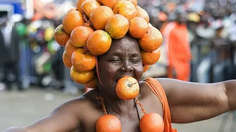 A supporter of Kenyan opposition leader Raila Odinga dressed in a costume made of oranges arrrives for a CORD (Coalition for Reforms and Democracy) rally, on May 31, 2014, in Nairobi.