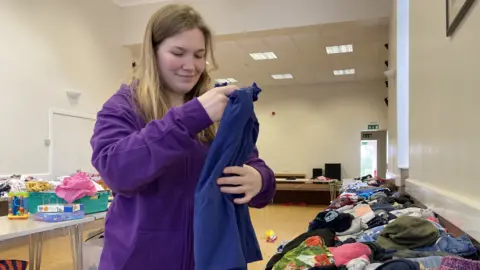 Volunteer Rebecca Gilbert prepares for the latest village hall swap shop.