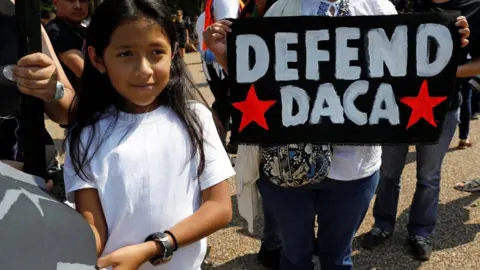 Reuters Demonstrators hold signs during a protest in front of the White House, 5 September