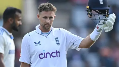 Joe Root celebrates his century