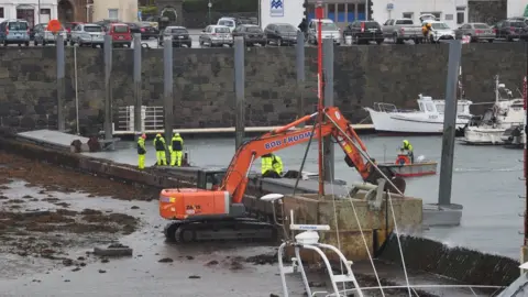 Repairs being carried out to piling and pontoon wall