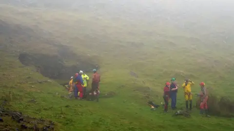 PA Media Rescuers at the entrance of the Ogof Ffynnon Ddu caves, 8 November 2021