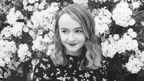 Efa Lois Efa Lois in front of flowers