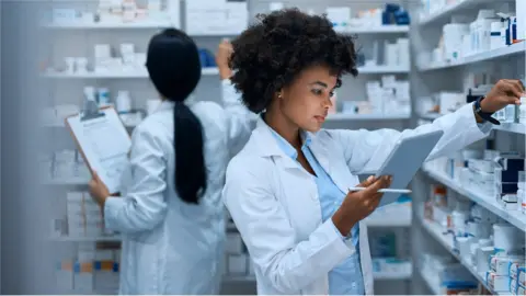 Getty Images Pharmacists checking stock