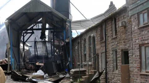 PA Media Remains of part of the damaged building at the scene, 18 July 2015