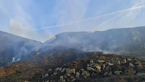 Derbyshire Fire and Rescue An area of steeply sloping moorland from which a quantity of smoke is rising
