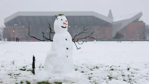 Reuters A snowman is seen outside Anfield before the match against Manchester United. Snow can be seen all around the ground. 