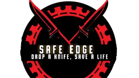 Portsmouth Academy A black and red circular logo has two crossed knives and the words "Safe Edge. Drop a knife, save a life".