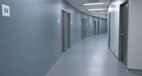 University of Nebraska Medical Center A sterile looking hallway with doors on either side