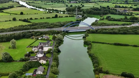 The River Bann has water that's bright green and the aerial image shows how similar the green is to the fields surrounding the river. 