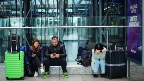 PA Media Stranded passengers at Heathrow Terminal 5 in London.