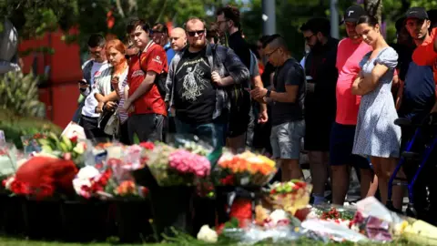 Fans stood near tributes at Anfield