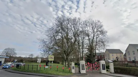 Entrance to a park with blue and grey skies above