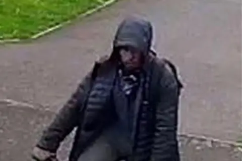 Crimestoppers A grainy CCTV still of a hooded man on a pushbike