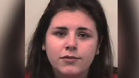 A police mugshot of Adele Rennie looking directly at the camera