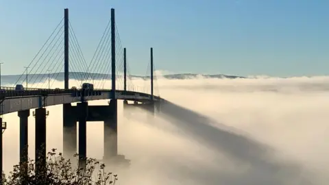 Tim Lloyd A bridge emerging from the mist while casting long shadows