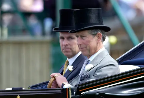 Tim Graham Photo Library via Getty Images The then Prince Andrew and then Prince Charles wearing top hats arriving in an open carriage on the second day of Royal Ascot in 2002 
