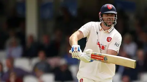 Paul Walter watches the ball as he plays a shot out through the off side during a match for Essex