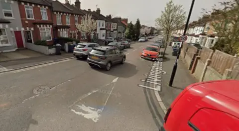 Residential street in Thornton Heath lined with terraced houses and parked cars, viewed from Livingstone Road.