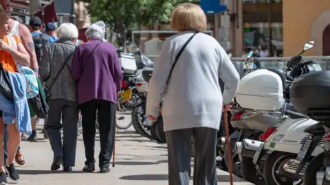 Getty Images Older women in Mallorca walk with sticks