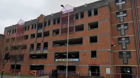 Google A red brick building that is five storeys high