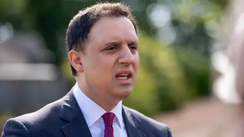 PA Media Anas Sarwar, who has short dark hair, in a business suit 