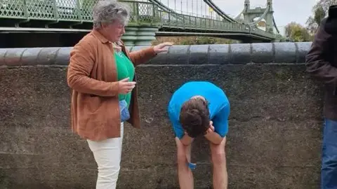 Tom Harding Tom Harding with his head in his hands bent over and his mum next to him comforting him at the end of the challenge
