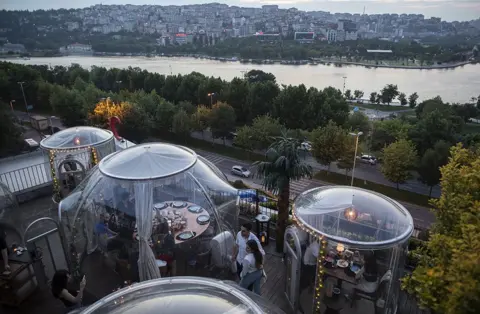 Erdem Sahin / EPA-EFE Diners in domes at a restaurant in Istanbul