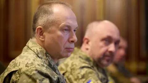 Side view of Syrsky, who is wearing camouflaged military uniform 