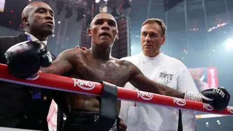 Conor Benn is consoled by his father Nigel and trainer Tony Simms
