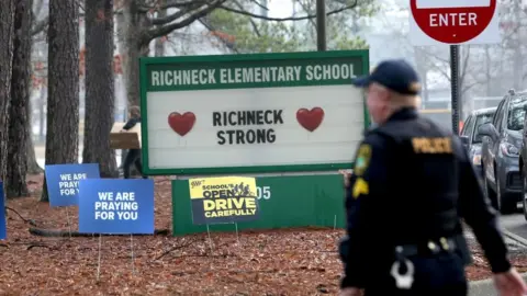 Getty Images Officers on site as students begin to arrive for their first day back at Richneck Elementary School