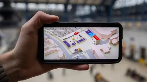 A 3D map of Brighton station on a phone, showing the concourse, shops, ticket buying facilities and platforms