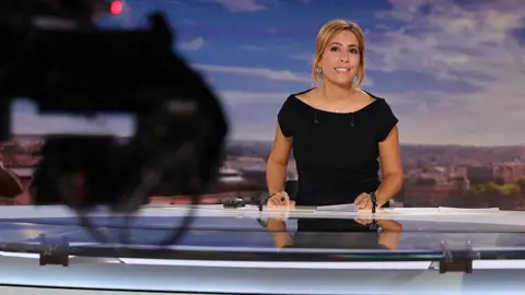 French journalist Lea Salame hosts the evening news broadcast of French television channel France2