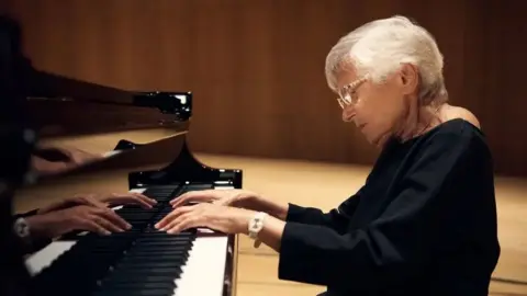 Ruth Slenczynska, pictured at the age of 97, plays the piano in a wood-lined recording studio