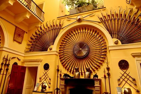 Graham Christie Swords and shields have been erected on the wall in beautiful patterns.