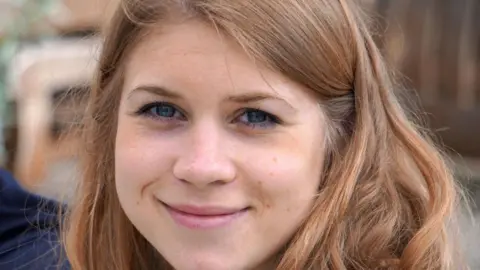 Family handout Sarah Everard, with light brown hair and blue eyes, is shown smiling and looking directly into the camera
