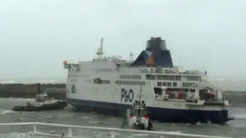 AFP Tugs work to free the ferry in Calais. 10 December