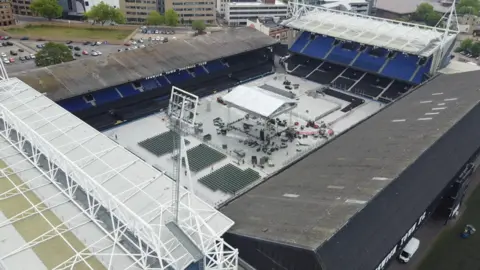 Jamie Niblock/BBC A drone photo shows a wide shot of Portman Road stadium, with construction of the boxing ring ongoing
