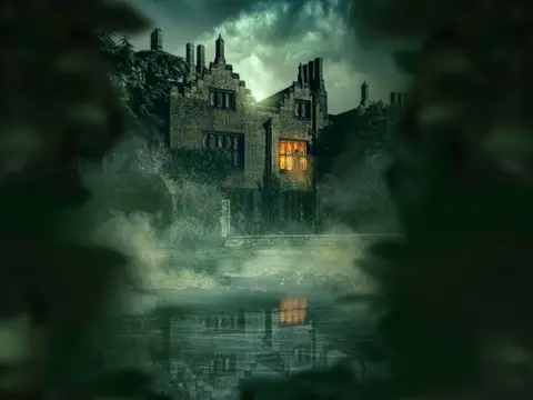 Greenway Entertainment A promo image of an old-looking building shrouded in green mist. There is orange light in one window on the first floor. The house is reflected in water in the foreground.