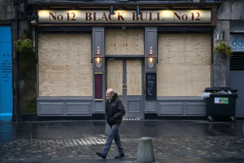 Getty Images Boarded up pub in lockdown