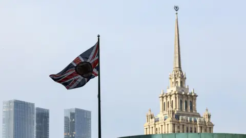 A British flag flies above the British embassy on the Moscow skyline 