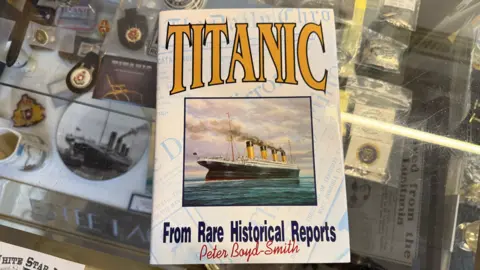 A white book with blue and yellow writing on it. The cover of the book reads Titanic From Rare Historical Reports Peter Boyd-Smith