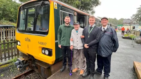 BBC People on the platform at Great Torrington Station with a train in the background