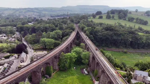 A drone view of a Victorian viaduct through a valley