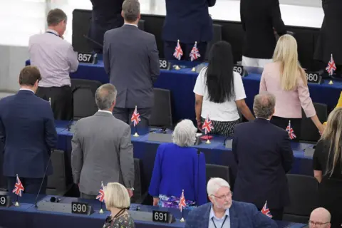 Getty Images Brexit Party MEPs turn their backs during the European anthem ahead of the inaugural session at the European Parliament, 2019