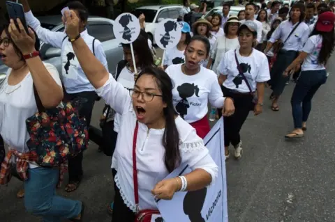 AFP/Getty Images Protesters walk to the Central Investigation Department (CID) during the demonstration demanding justice for a two-year-old who was raped and given the pseudonym "Victoria" in Yangon on July 6, 2019.